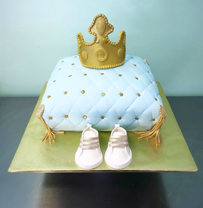 A baby prince-themed cake, perhaps with a crown and blue or gold accents.