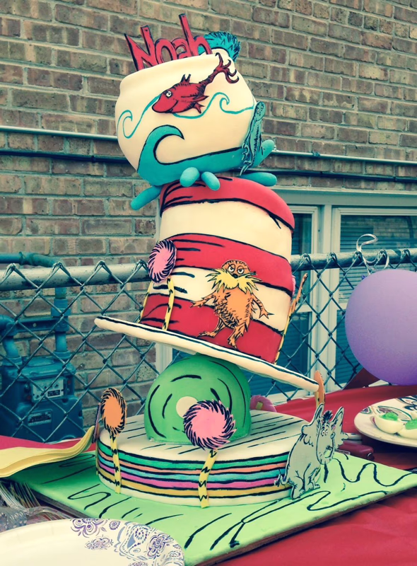 A whimsical cake inspired by Dr. Seuss, featuring bright colors and playful characters.