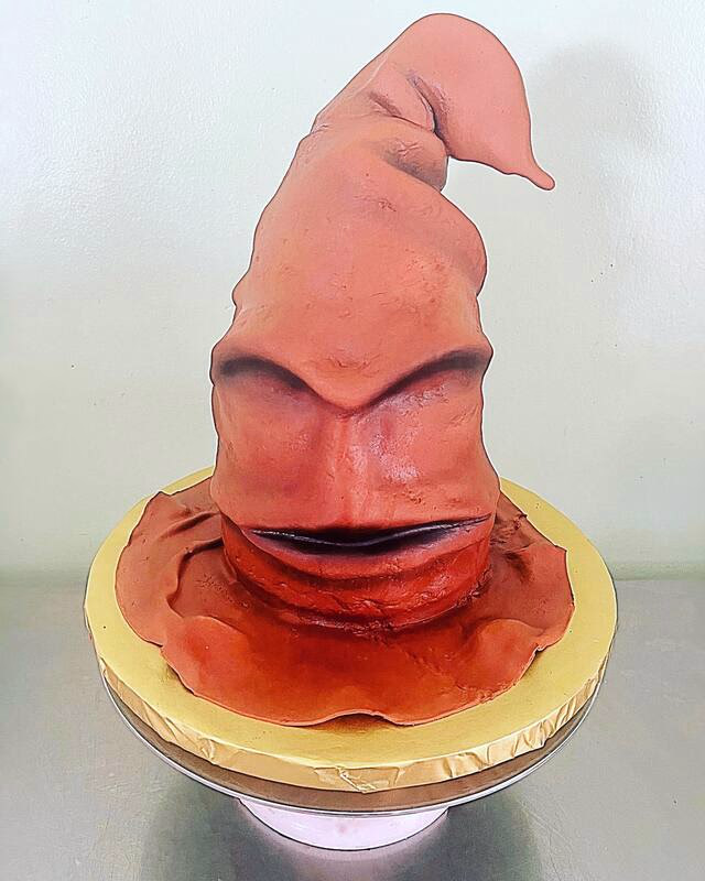 A Harry Potter themed cake featuring the iconic Sorting Hat, possibly with house colors.