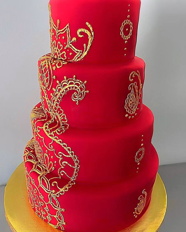 A majestic tiered cake featuring a red dragon, possibly with intricate scales and fiery details.