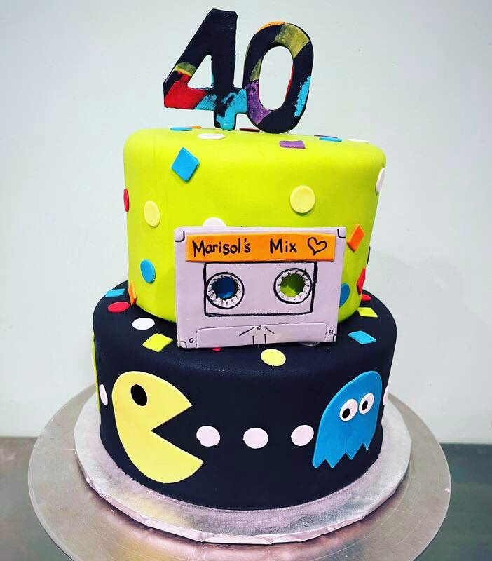 A cake with a vibrant retro theme, featuring nostalgic colors and designs from past decades.