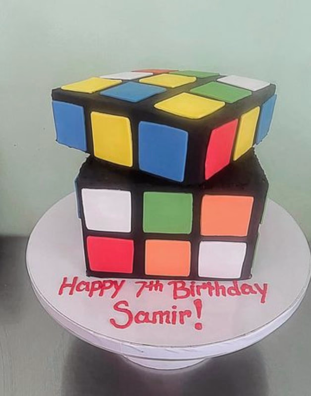 A clever cake designed to look exactly like a colorful Rubik's Cube.