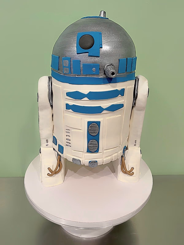 An impressive Star Wars cake designed to replicate the iconic droid R2D2.