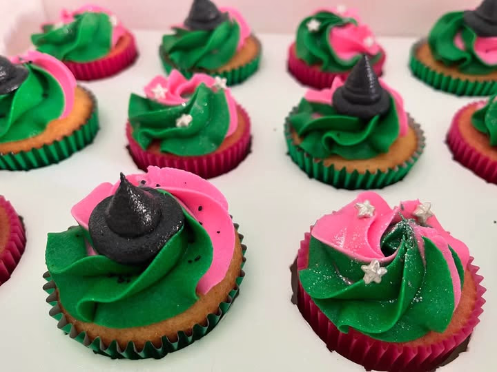 Pink and green cupcakes with star and silver sprinkles.