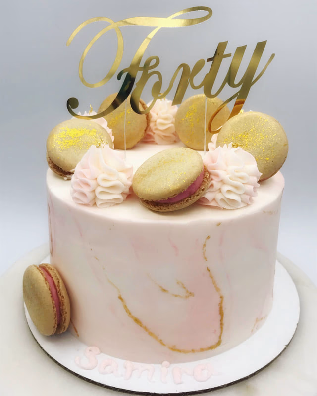 A celebratory 40th birthday cake, elegantly decorated with gold accents.