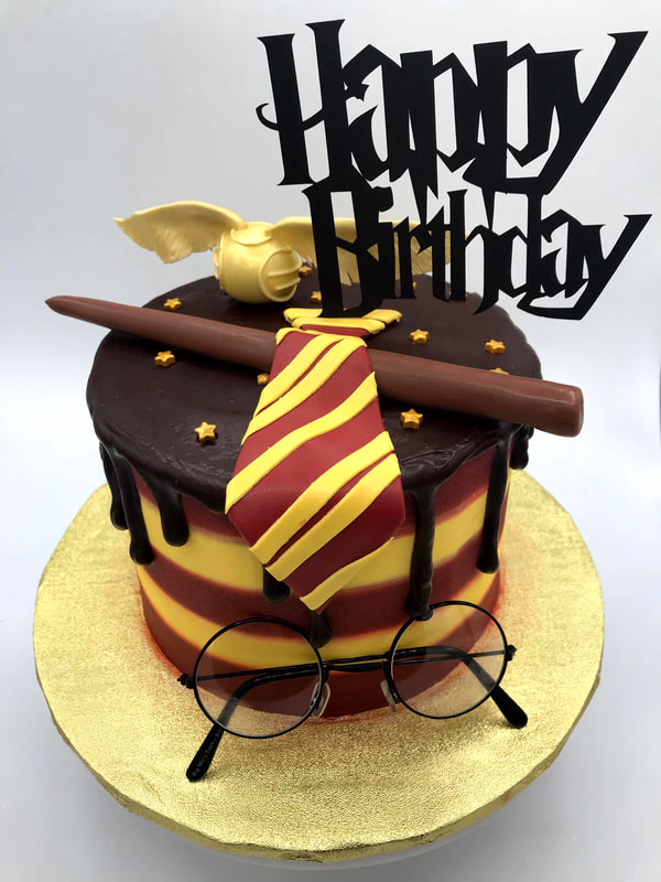 A magical Harry Potter wizard themed cake, incorporating elements like wands or spell books.