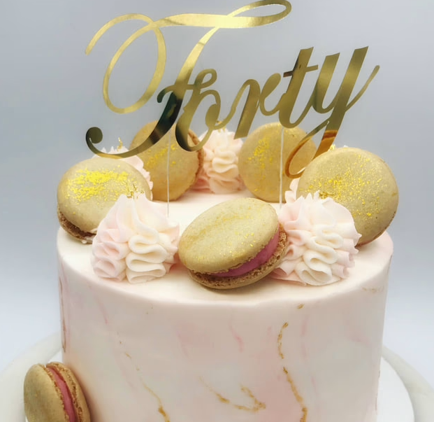 A celebratory 40th birthday cake, elegantly decorated with gold accents.